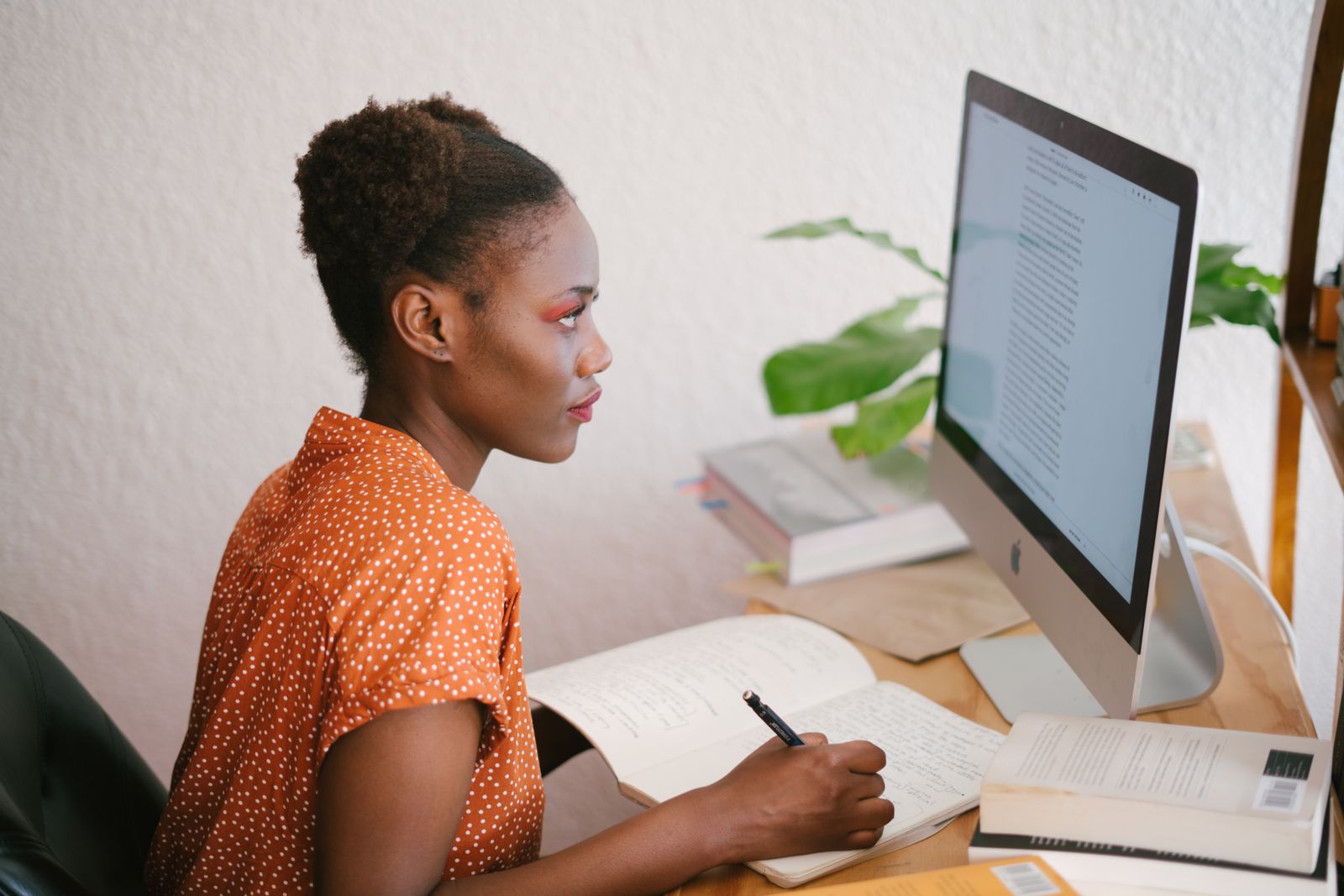 Person writing business content on a laptop keyboard