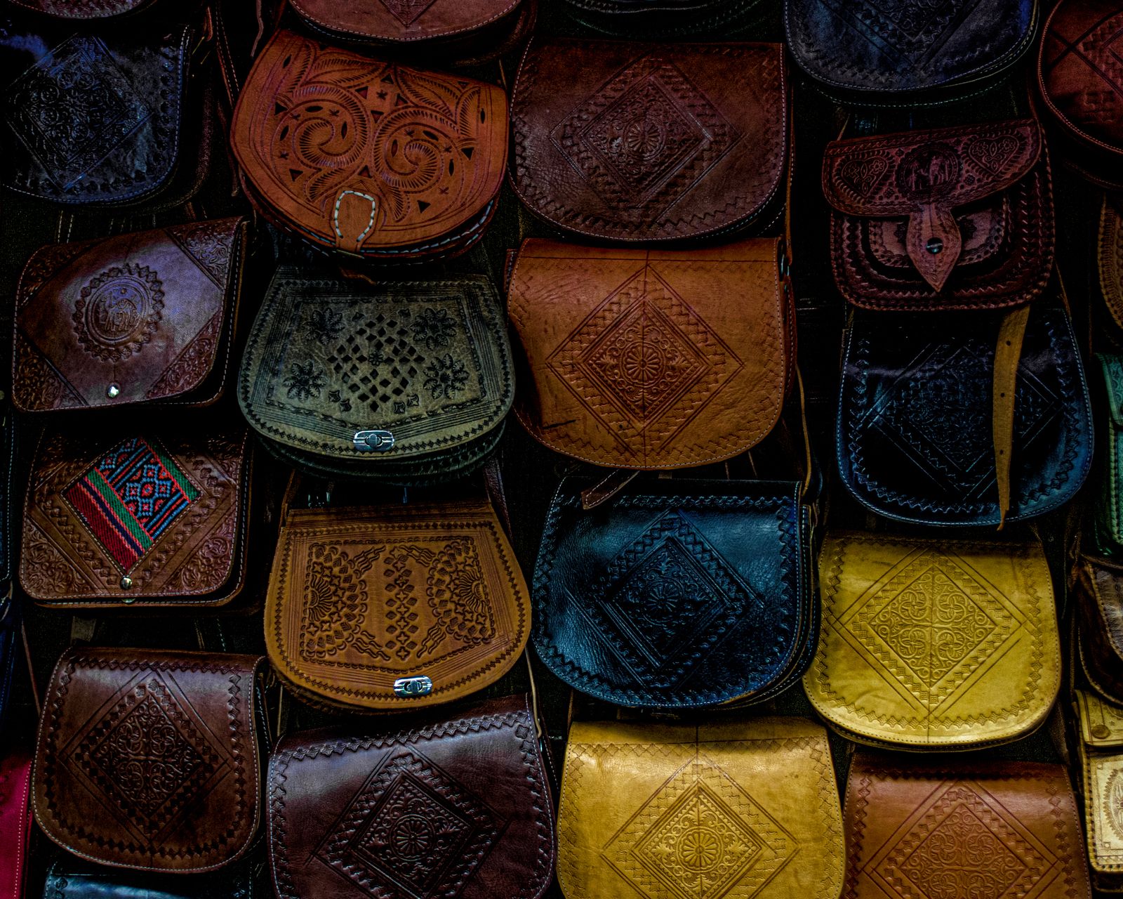 Outdoor display of varied handmade leather bags