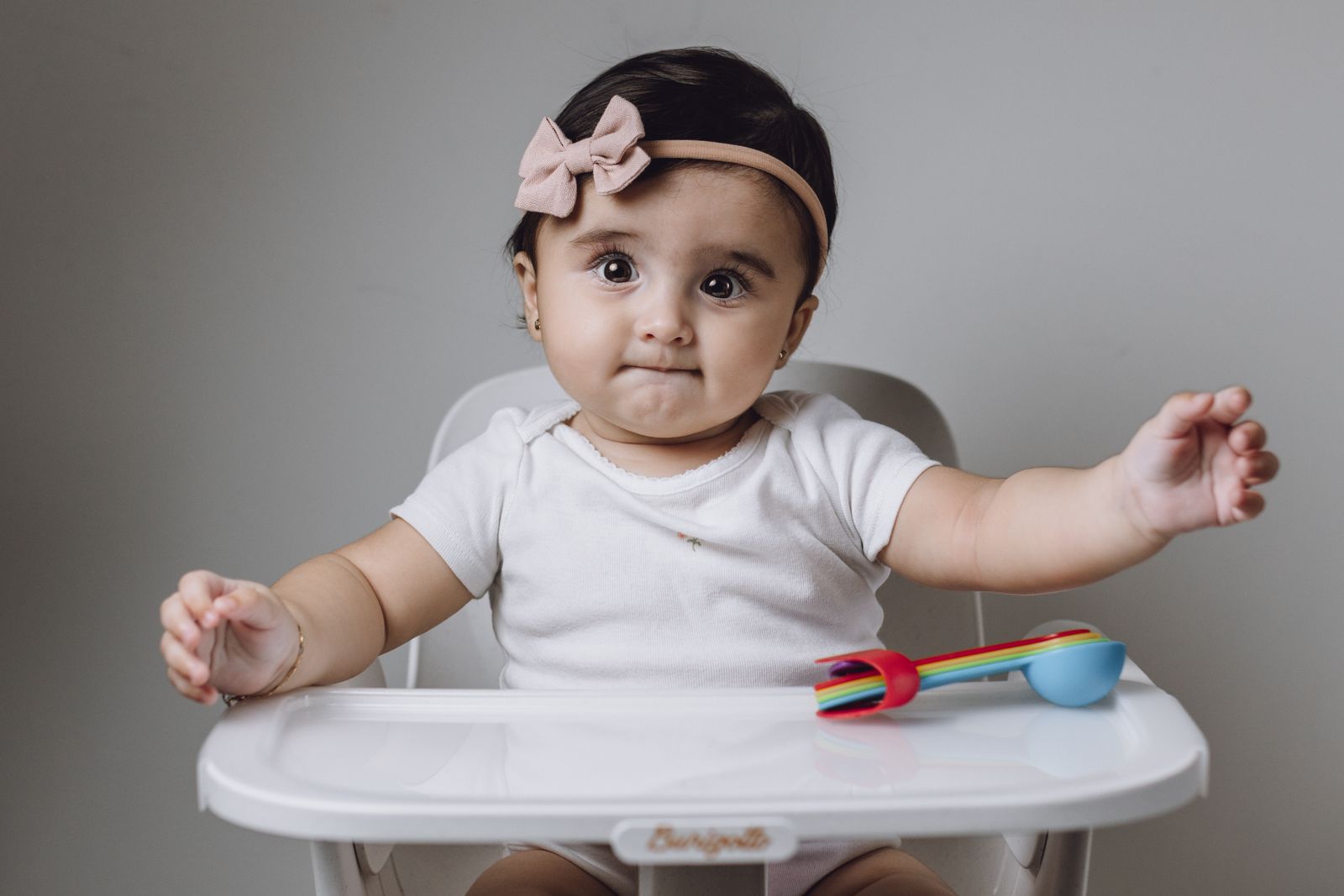Baby bibs and diapering supplies flat lay
