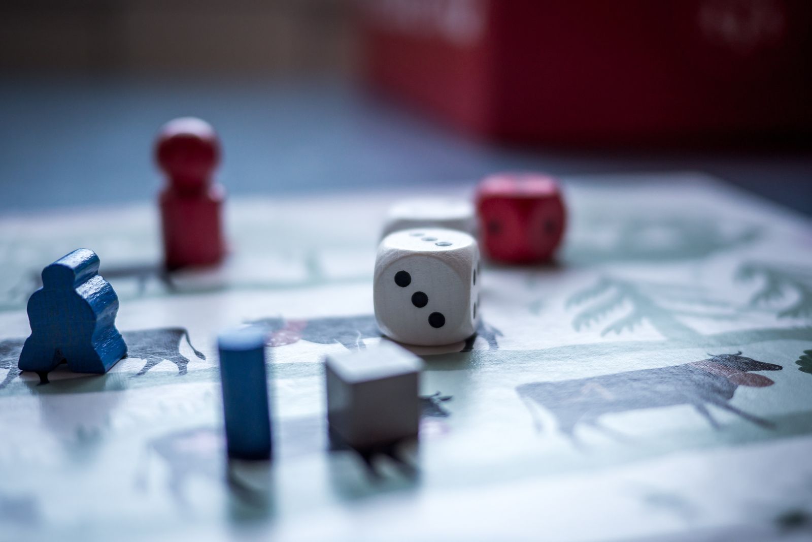 Board game dice and colorful playing pieces on a game board
