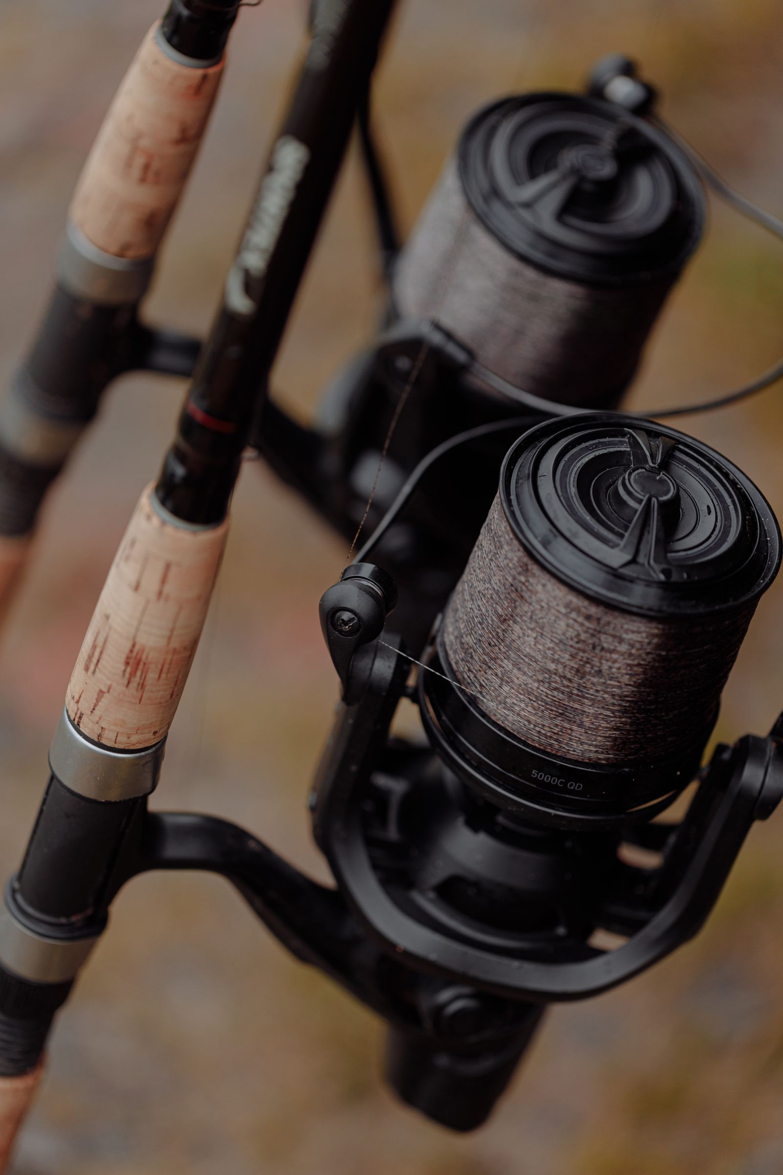 Fishing rod and reel on a dock at sunset