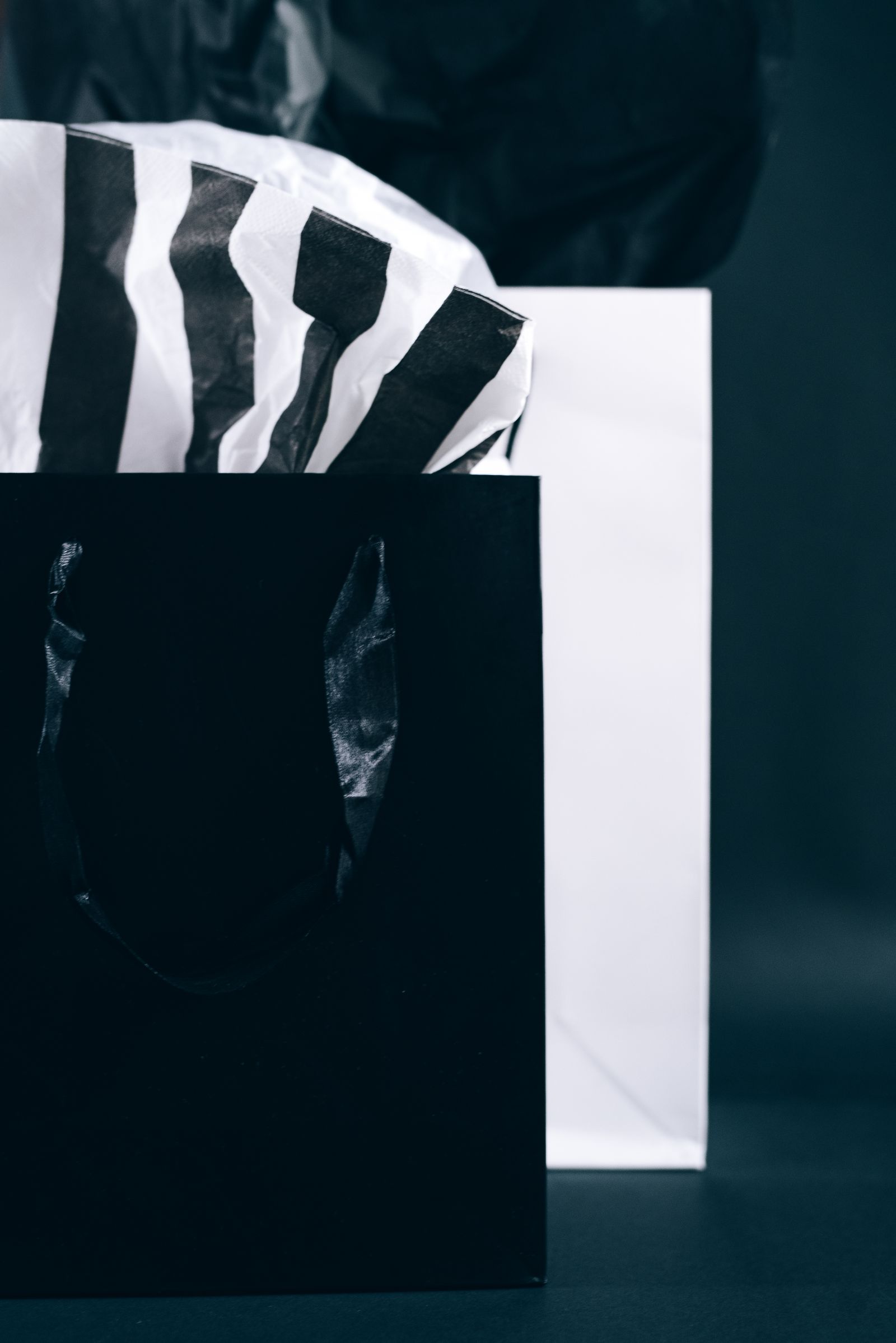 Black-and-white shopping bags with tissue paper